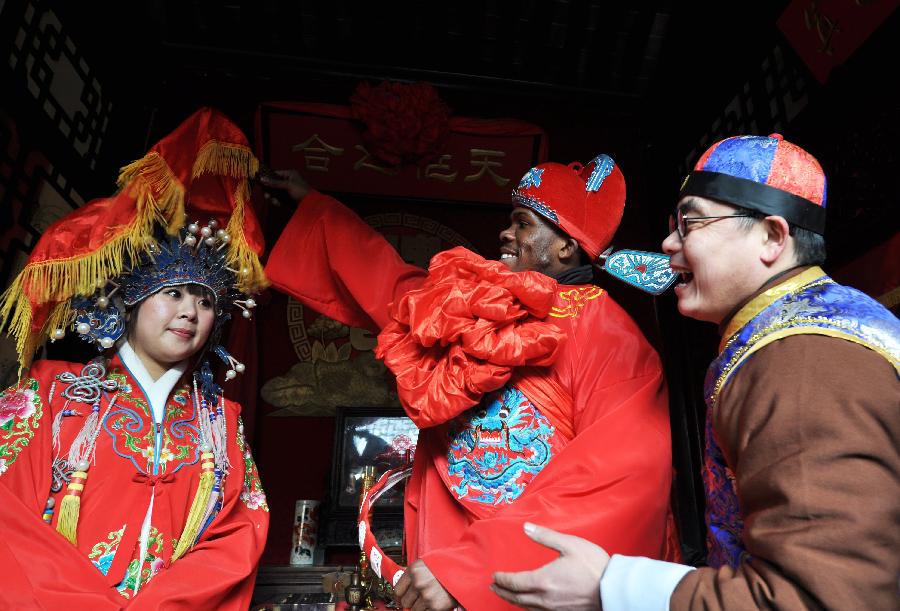 A Ghanaian student C plays the bridegroom in a Chinese wedding ceremony 