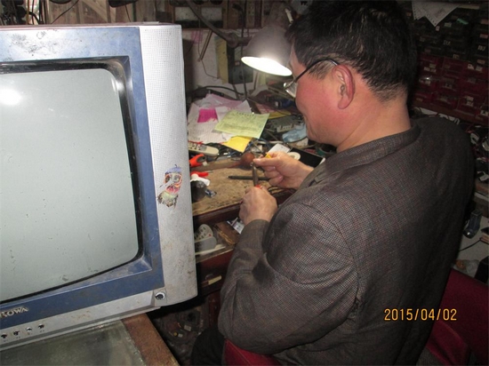 高尚义正在修电视机